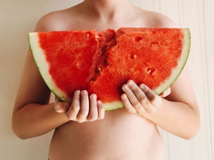 Close-up of woman holding a slice of watermelon