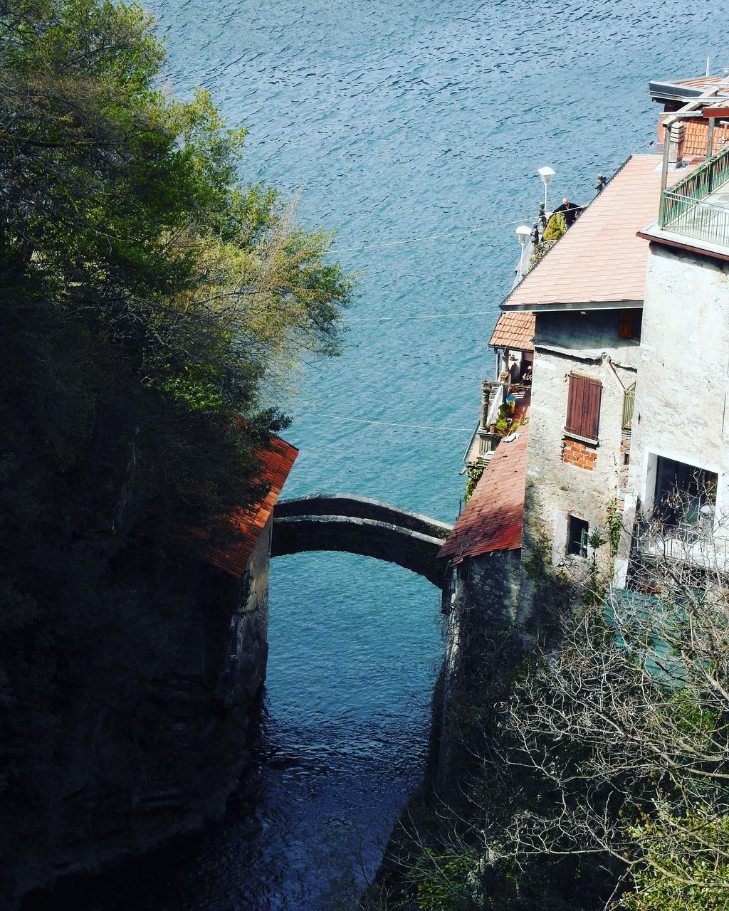 HIGH ANGLE VIEW OF BRIDGE OVER RIVER BY BUILDINGS