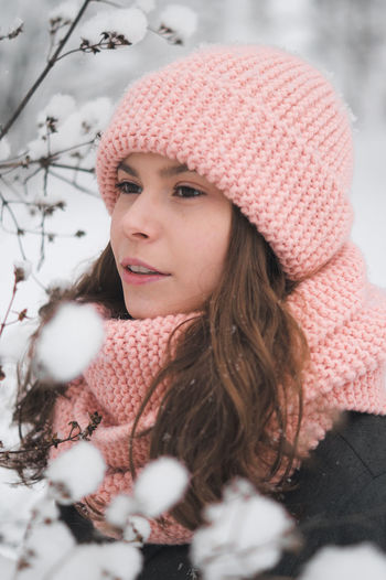 Portrait of woman looking away in snow