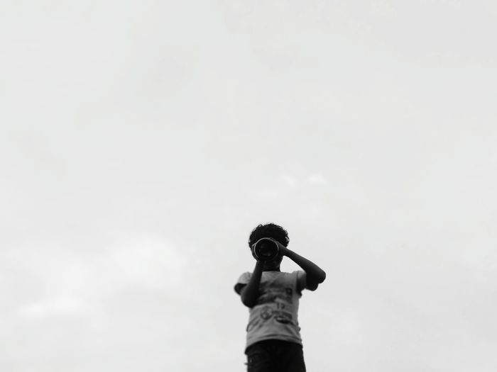 Low angle view of man standing against sky