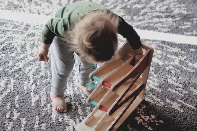 Small boy playing with wooden toy