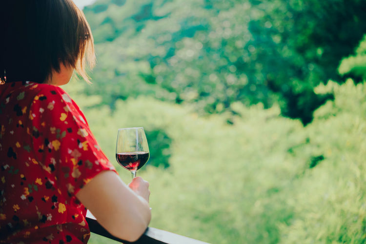 Rear view of woman drinking glass