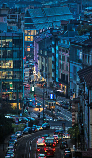 Traffic on city street amidst buildings