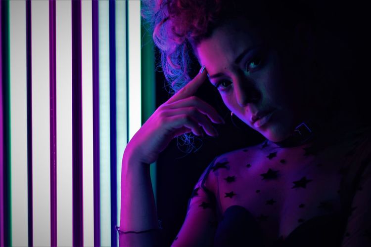 Model with pin up hairstyle with neon lights