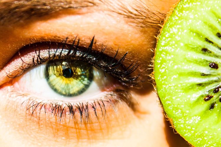 Close-up of kiwi by human eye