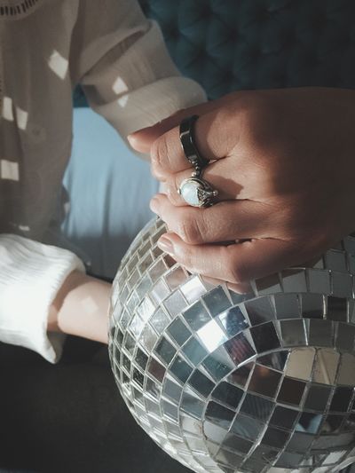 Close-up of woman holding disco ball