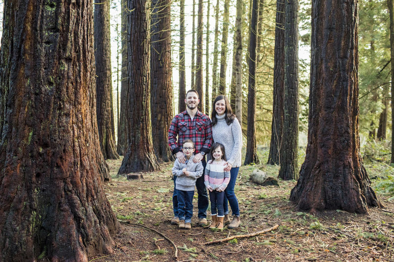 Portrait of attractive family in the forest.