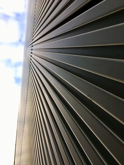 Close-up of metallic structure against sky