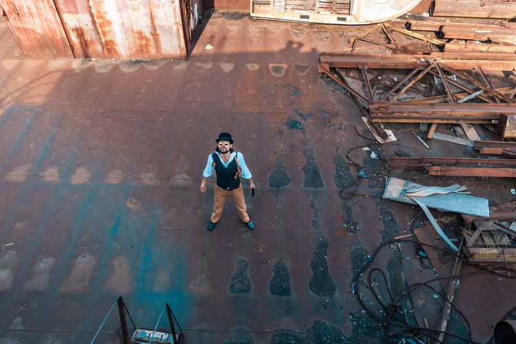 High angle view of man walking by building