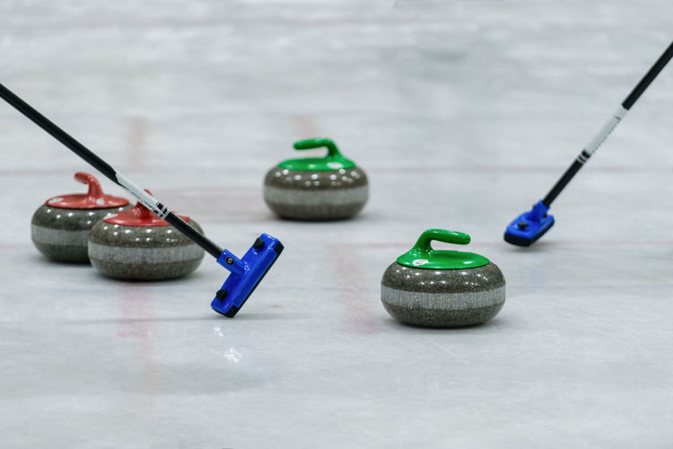 Close-up of curling stones on ice rink