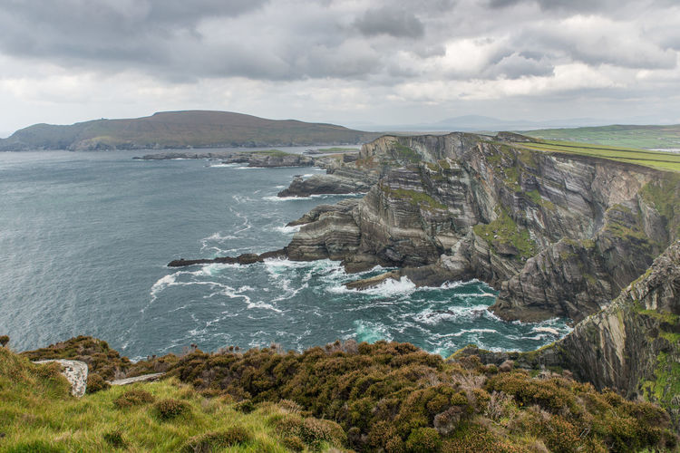 Scenic view of kerry cliffs portmagee against cloudy sky