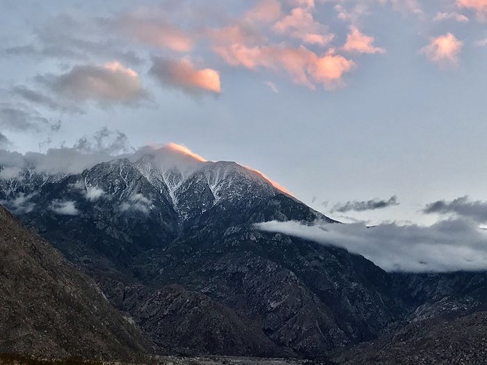 Scenic view of snowcapped mountains against sky during sunset