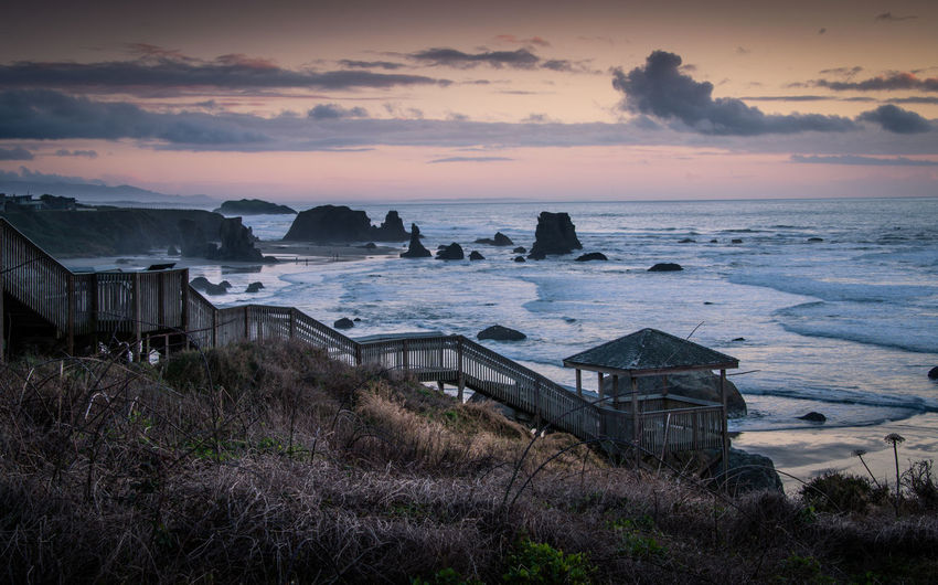 Stairs going down to the beach in bandon, oregon. moody winter photo
