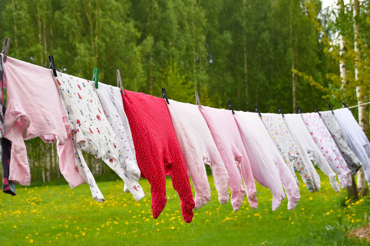 Clothes drying on clothesline, baby suits only.