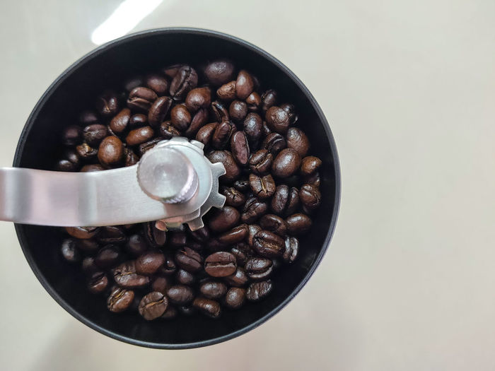 High angle view of coffee beans in glass on table