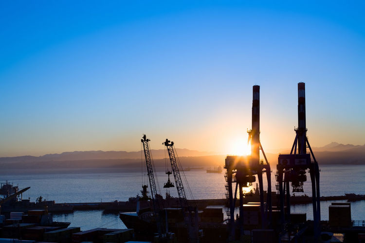 Silhouette view of cranes at port facilities at dawn, valparaiso, valparaiso region, chile.