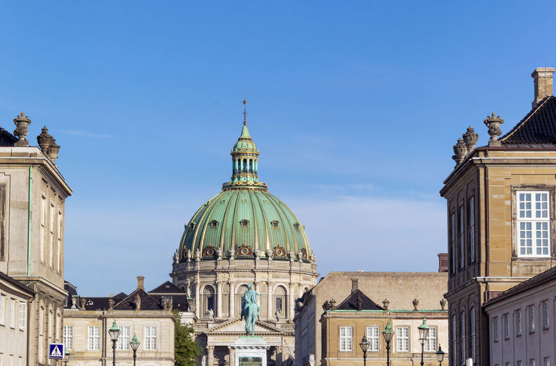 Amalienborg palace with dome of frederik's church and blue sky background