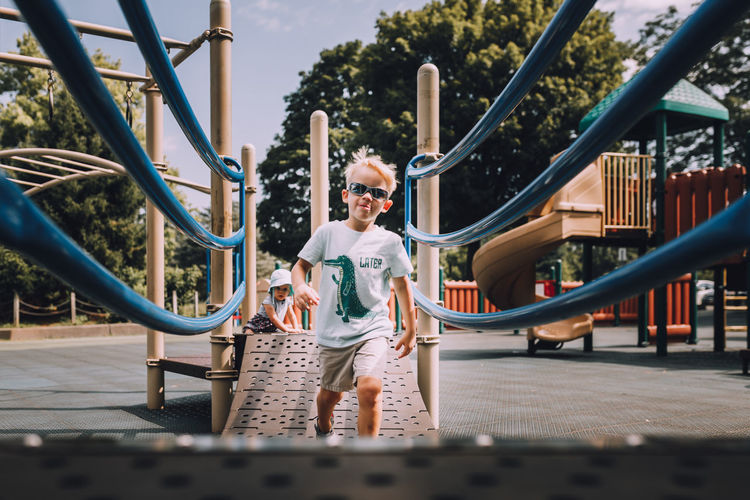 Boy playing on slide at park