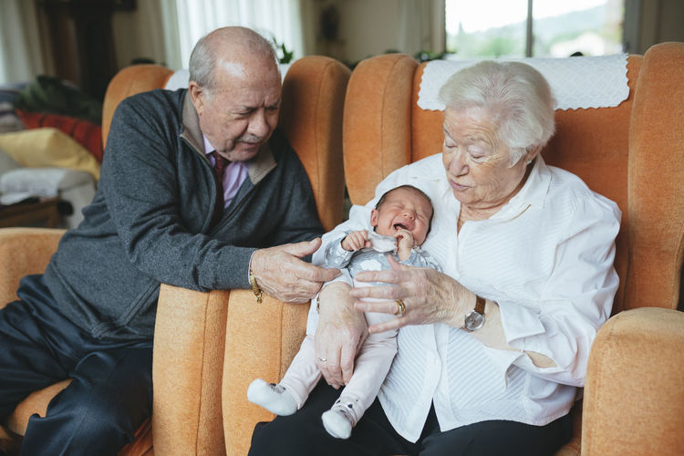 Great grandparents taking care of great granddaughter at home