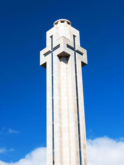 Low angle view of monumento a los caidos at plaza de espana against blue sky
