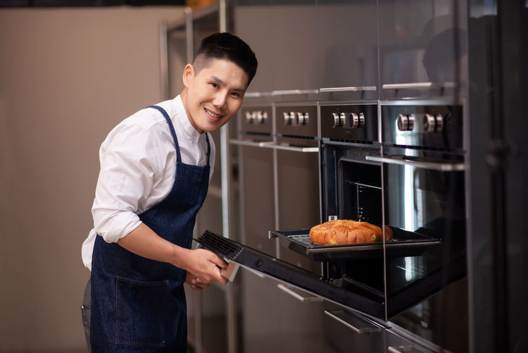 Young man preparing food in kitchen at home