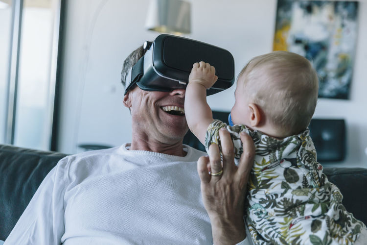 Happy man with baby wearing vr glasses