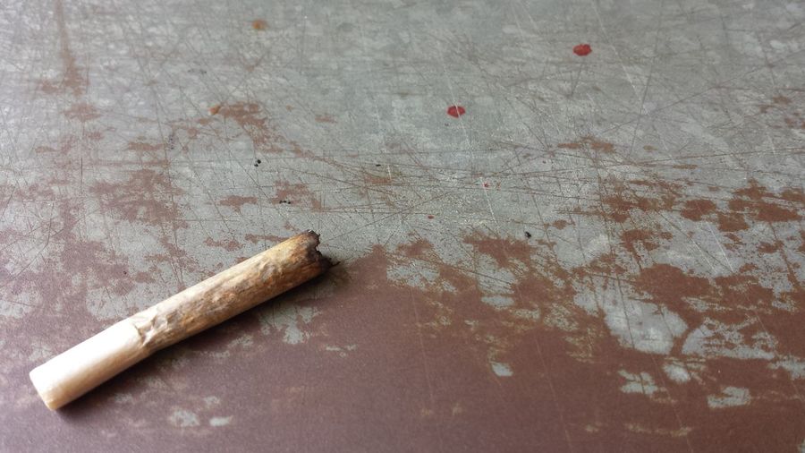 High angle view of cigarette on metallic table