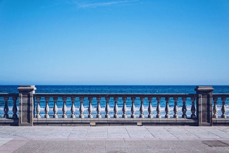 Scenic view of sea against clear blue sky