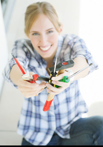 Portrait of confident female electrician working