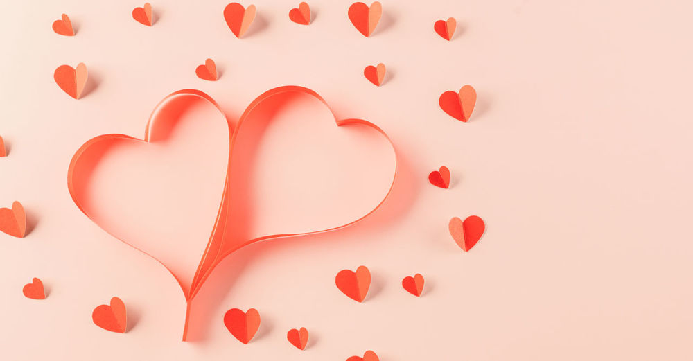 Directly above shot of heart shapes on pink background
