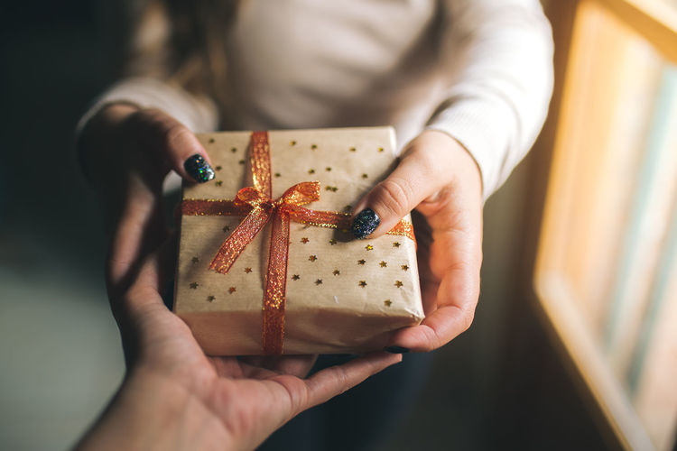Midsection of woman holding christmas present