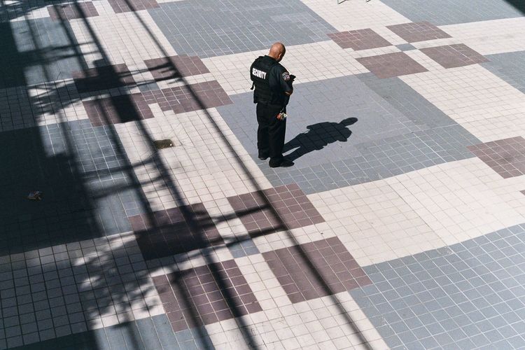 High angle view of man walking on zebra crossing