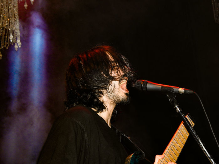 Portrait of man playing at music concert