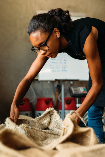 African American Beans Coffee Coffee Shop Examination Females Hands Quality Work Workplace Authentic Businesswoman Cafe Casual Clothing Factory Front View Indoors Lifestyles One Person Owner Produce Real People Roasting Sack