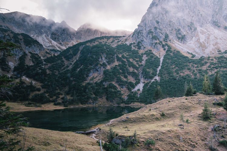 Scenic view of river amidst mountains against sky