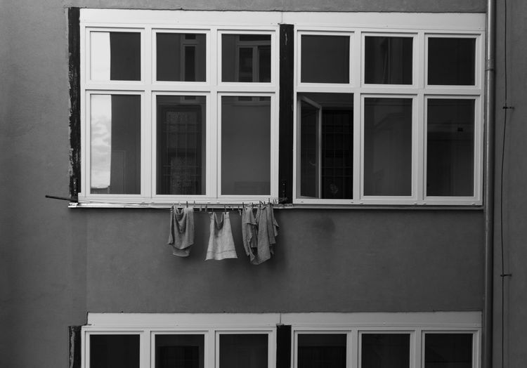 Laundry hanging on clothesline by window