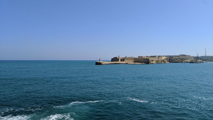 Scenic view of sea against clear blue sky