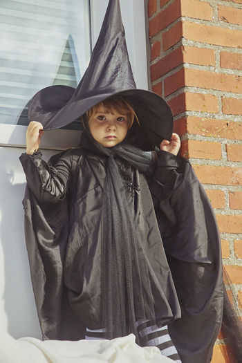 Adorable child on porch dressed in halloween costume