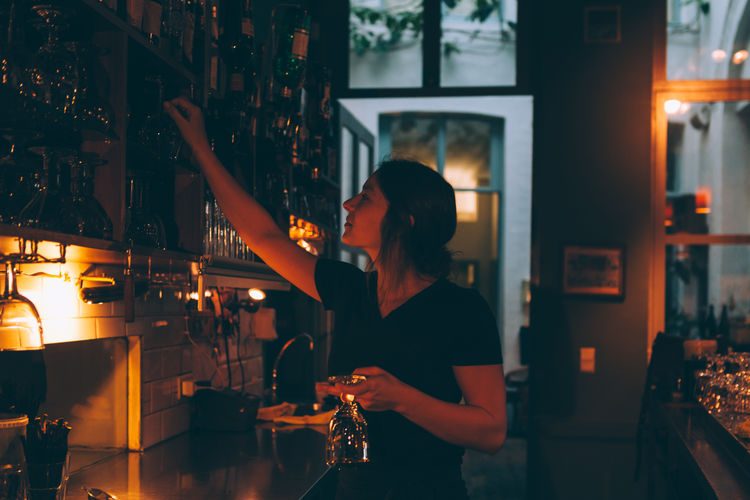 Female bartender working behind the bar