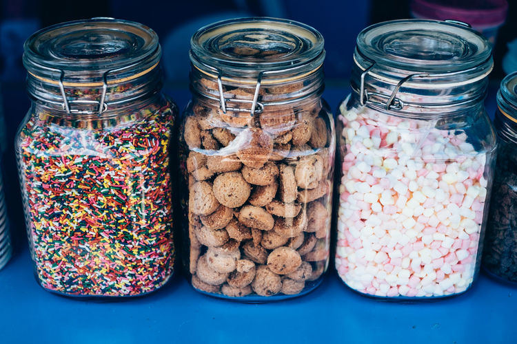 Close-up of sweet food in jars at store
