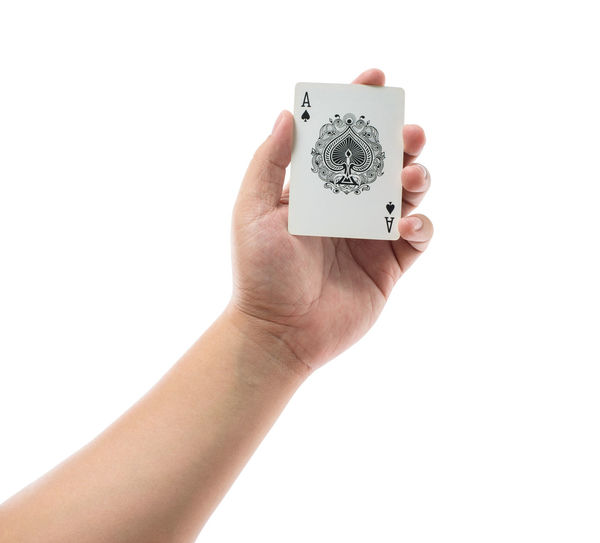 Close-up of hand holding paper over white background