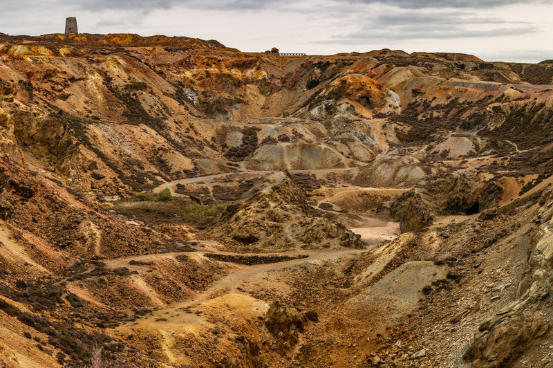 The orange and brown landscape of the disused parys mountain copper mine, anglesey, north wales.