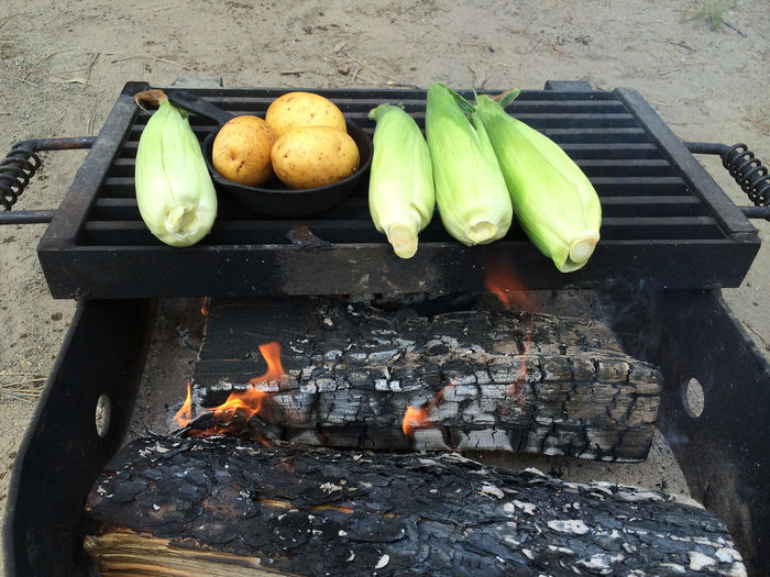 Corns and potatoes being grilled outdoors