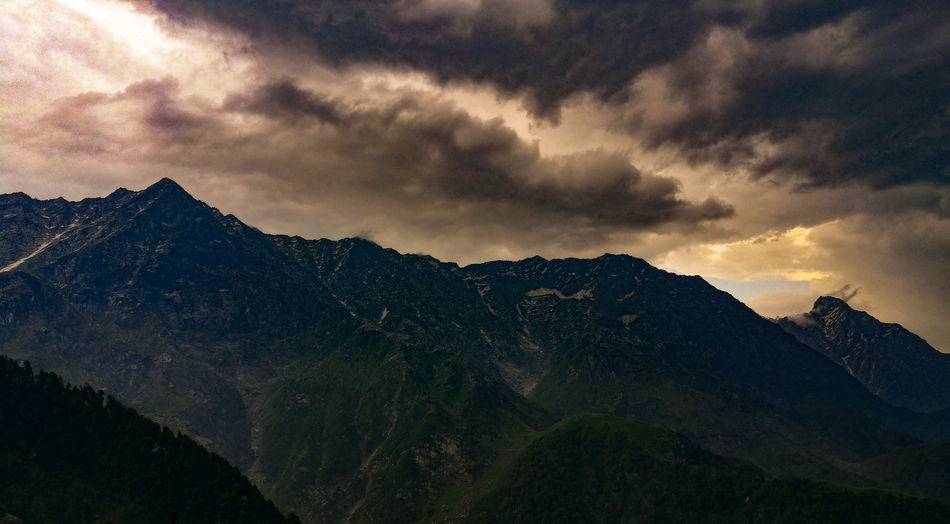 Scenic view of mountains against sky at dusk