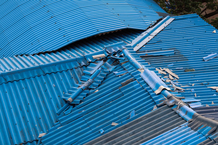 High angle view of metallic roof against blue sky
