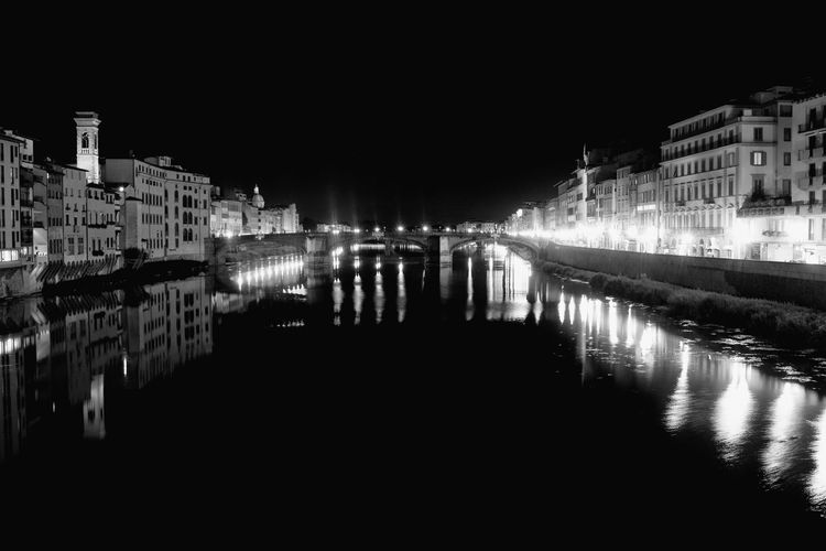 Illuminated buildings with waterfront at night