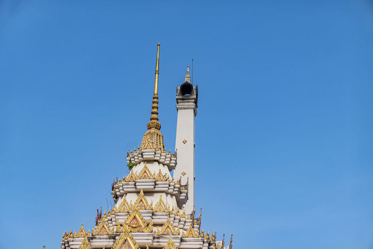 Low angle view of thai crementorium building against clear blue sky