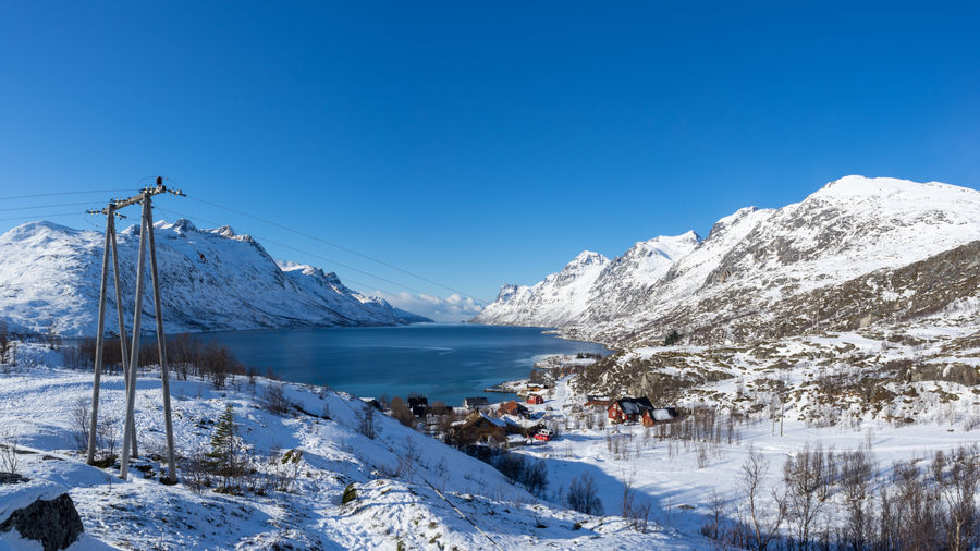 Sunny winter daytime view on erstfjordbotn, kvaloya, tromso, norway with fjord, sea, mountains, snow