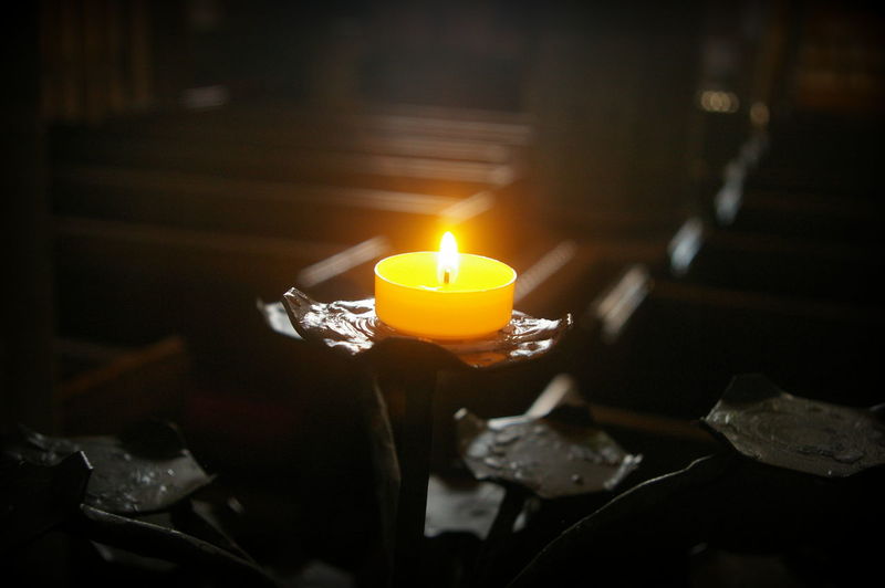 Illuminated candle on holder