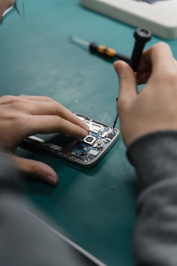 Midsection of man using calculator